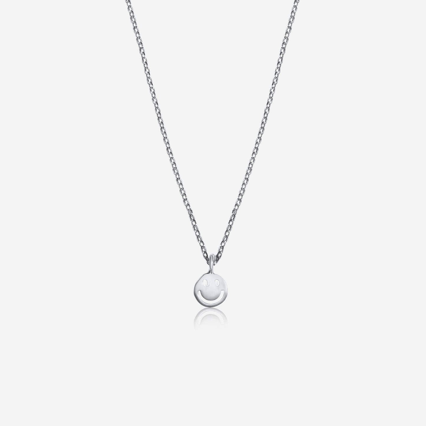 Silver necklace with a round pendant on a light gray background