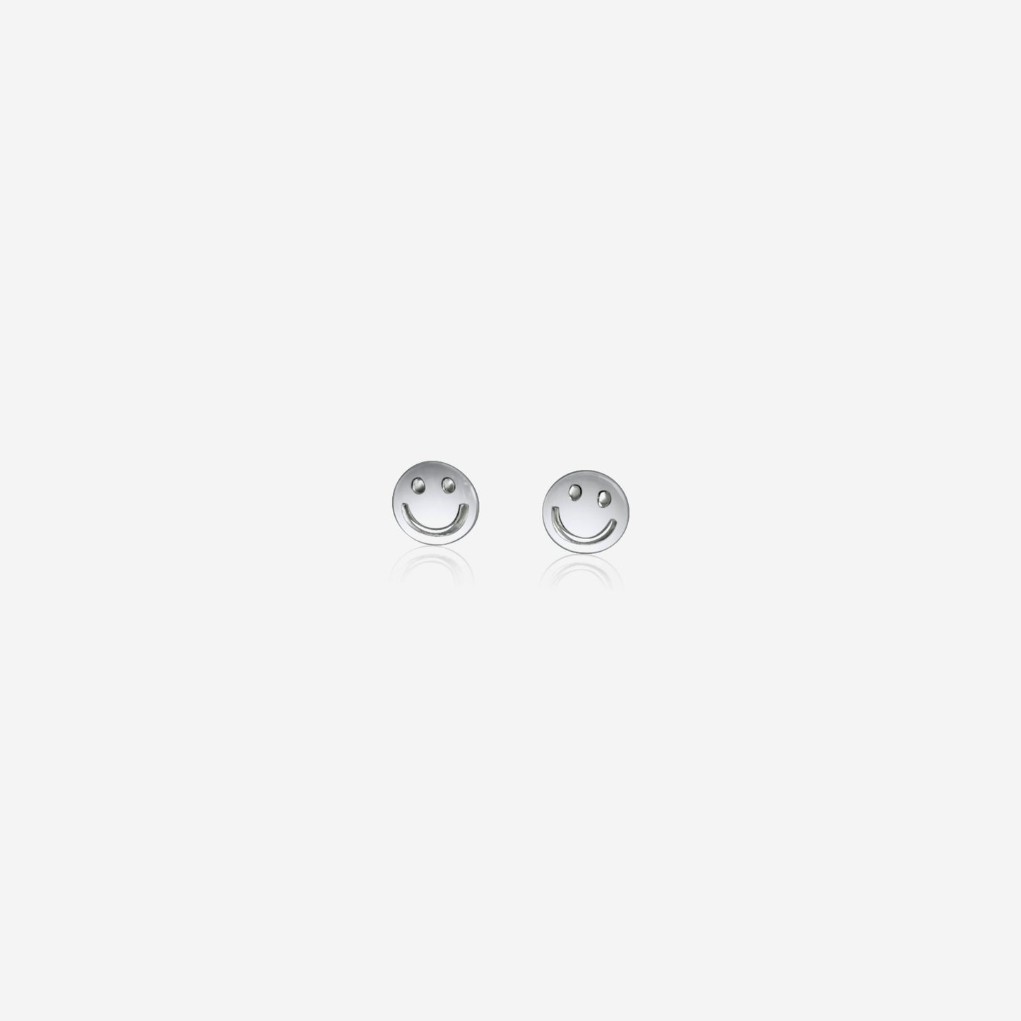 Pair of silver smiley face earrings on a white background