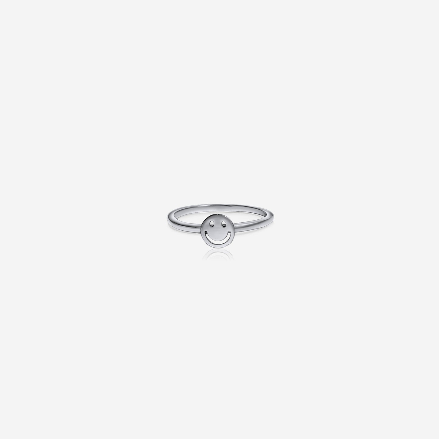Silver ring with a smiley face design on a white background