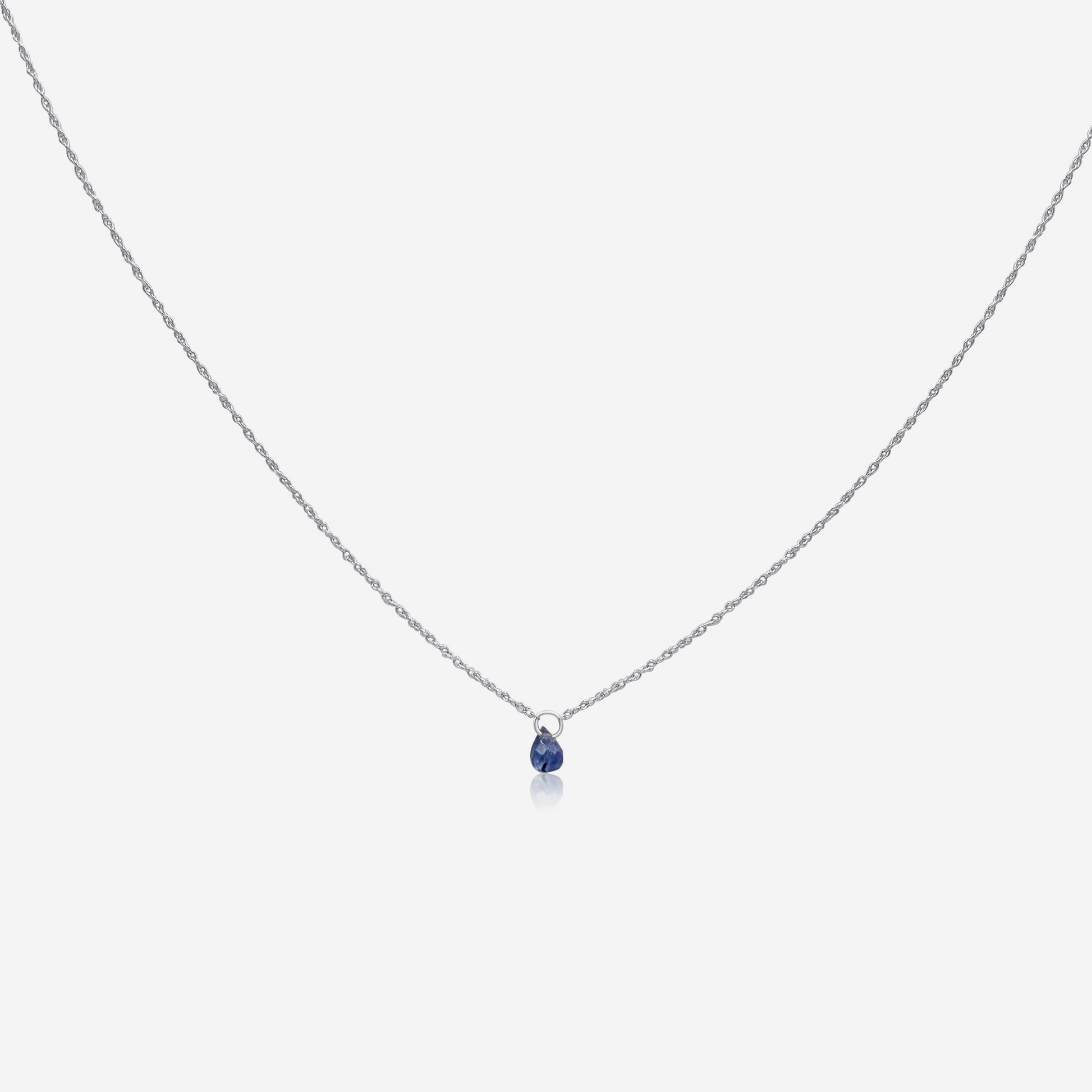 A single Tanzanite drop necklace on a gold chain against a white background.