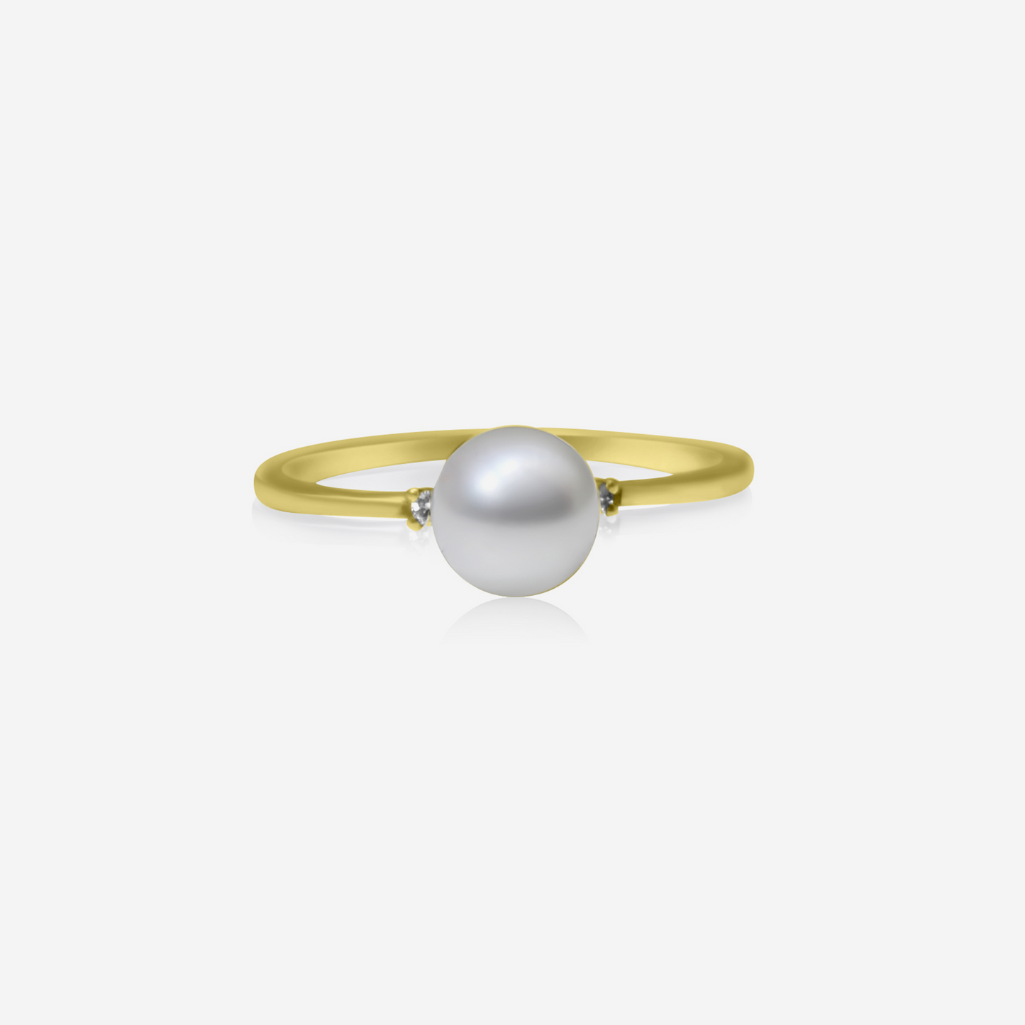 A gold ring with a central pearl and two side diamonds