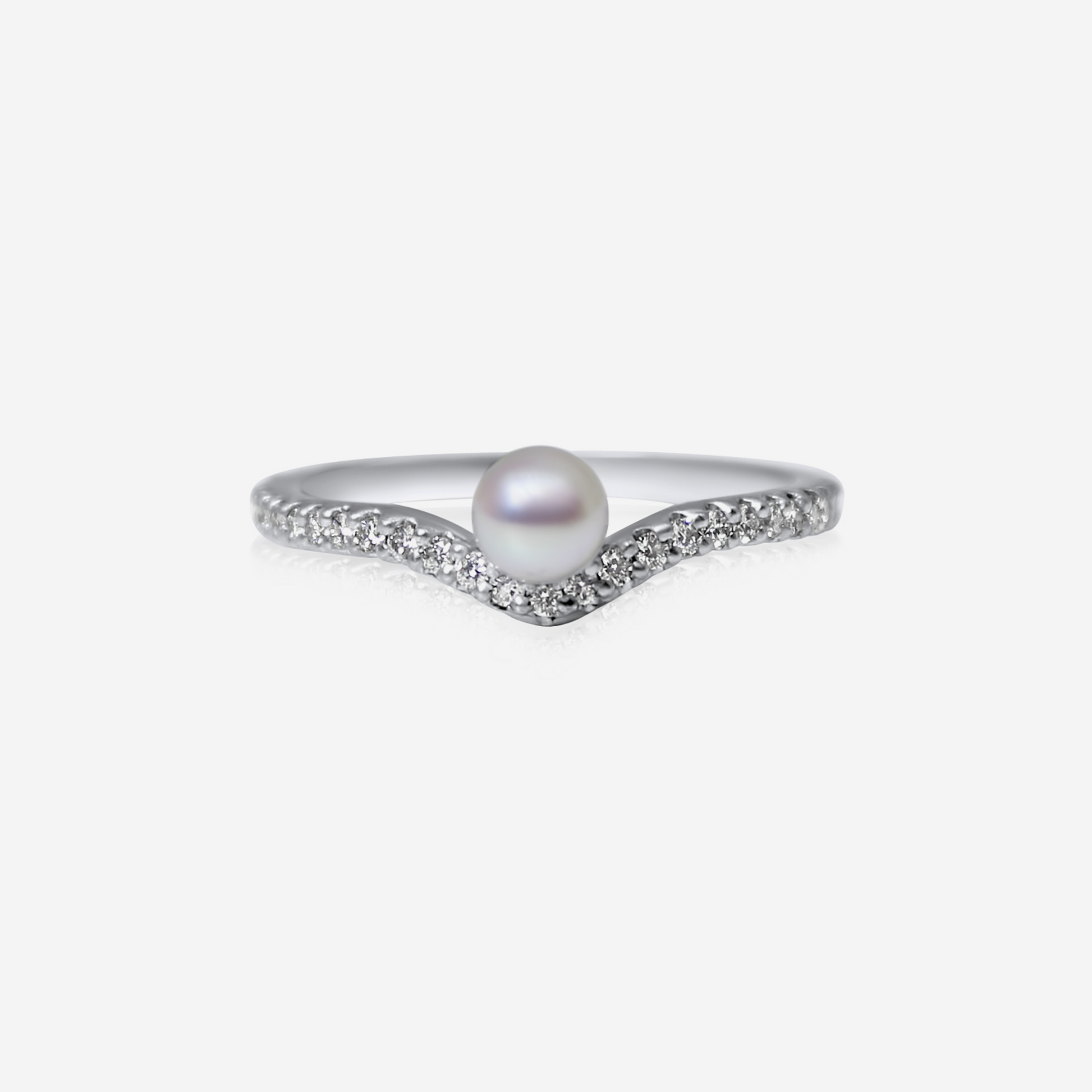 An elegant engagement ring featuring a central Akoya pearl surrounded by a recycled round brilliant cut white diamond band.