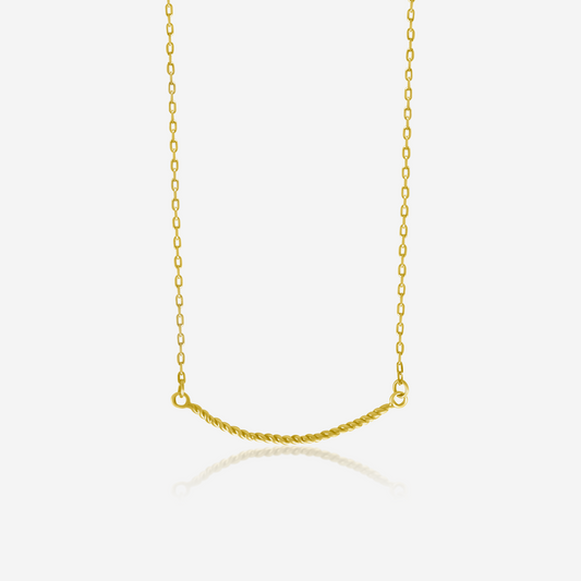 A twisted gold necklace on a plain background, showcasing its shiny gold finish and elegant design.