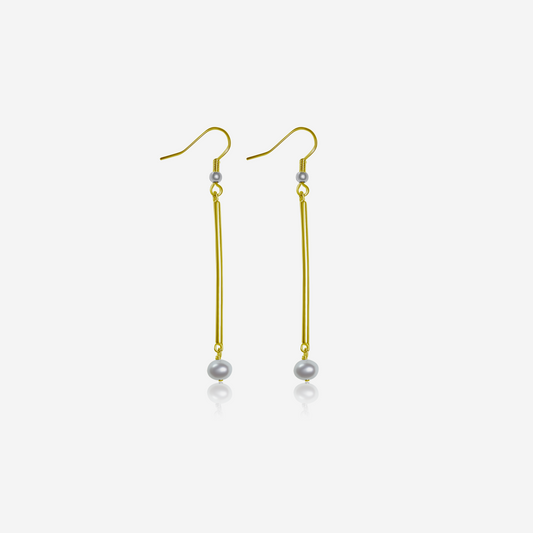 A pair of tube earrings with gold posts and freshwater pearls dangling.