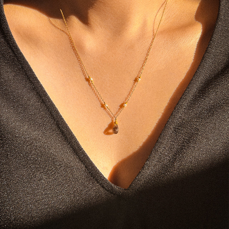 A Smoky Quartz with Tiny Akoya Pearl Necklace on a gold-tone chain with a single smoky quartz pendant and small pearls along the length.