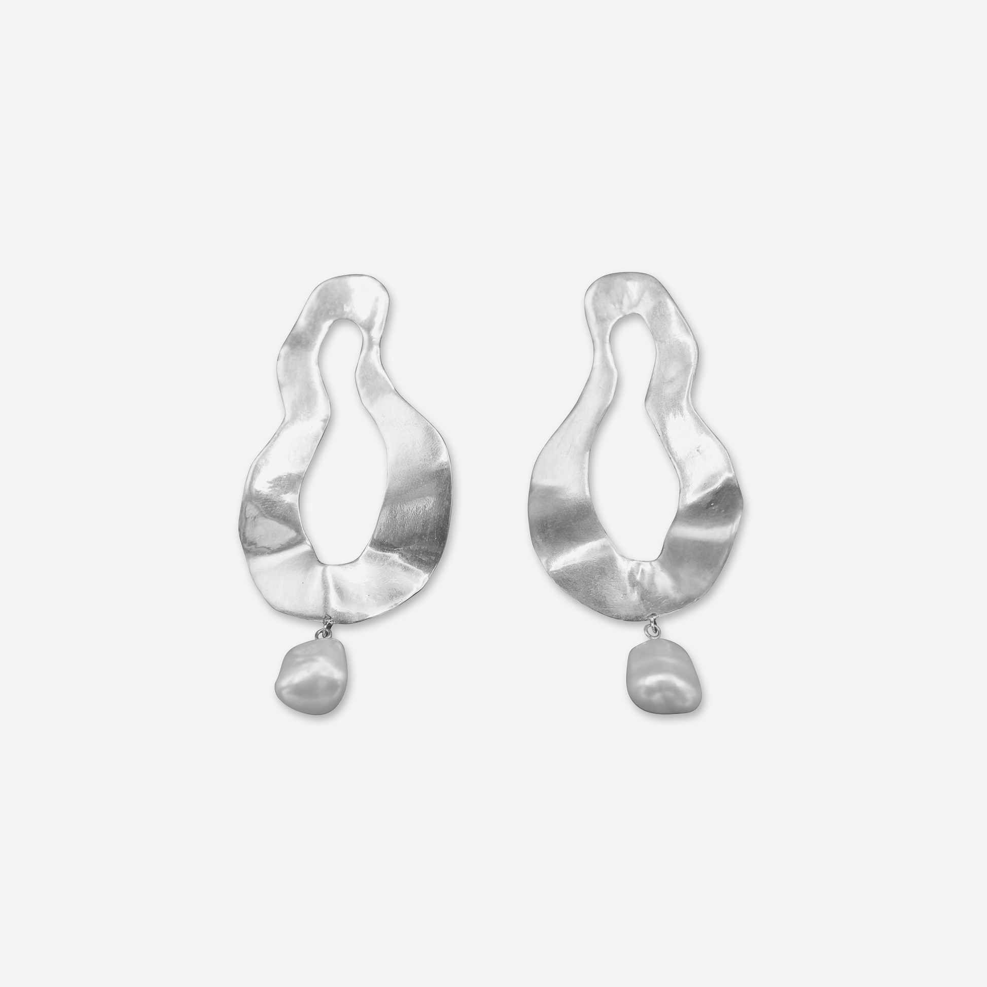 A pair of silver earrings with a matte finish, featuring a teardrop shape with a pearl dangling at the bottom.