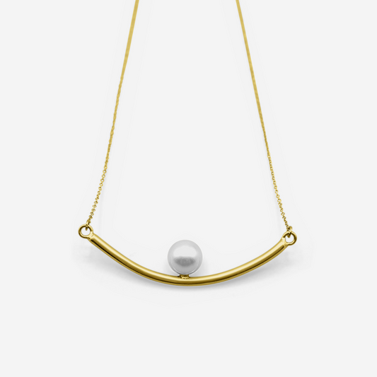 Gold necklace with a curved bar and pearl pendant on a white background