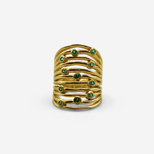 An 18-karat gold ring featuring multiple bands with small gemstones, presented against a white background.