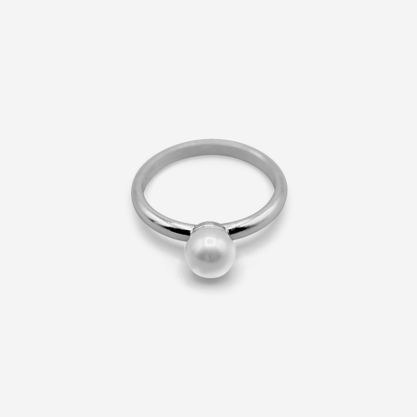 A single Akoya pearl ring with a gold band, presented against a white background.