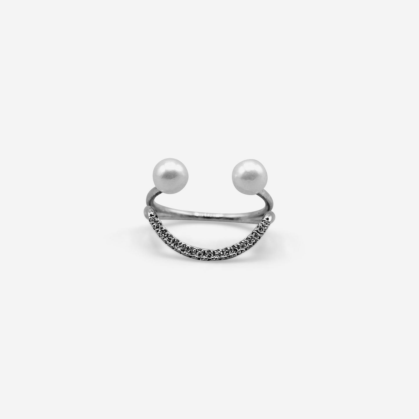 A 14 karat gold ring with a central Akoya pearl and white diamonds arranged in a semi-circular design, symbolizing a smile.