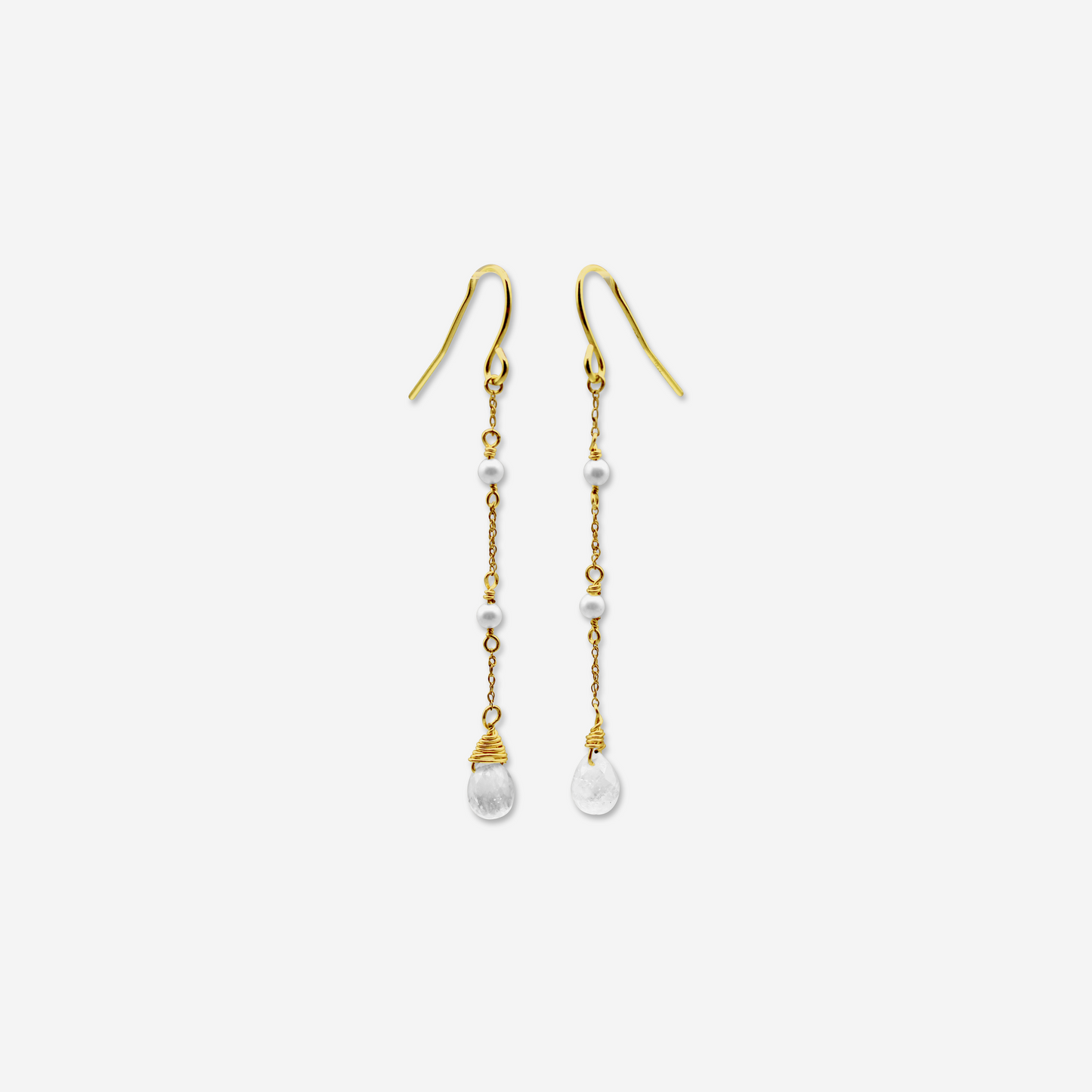 A pair of gold drop earrings featuring Akoya pearls and moonstone, with the earrings suspended against a white background.