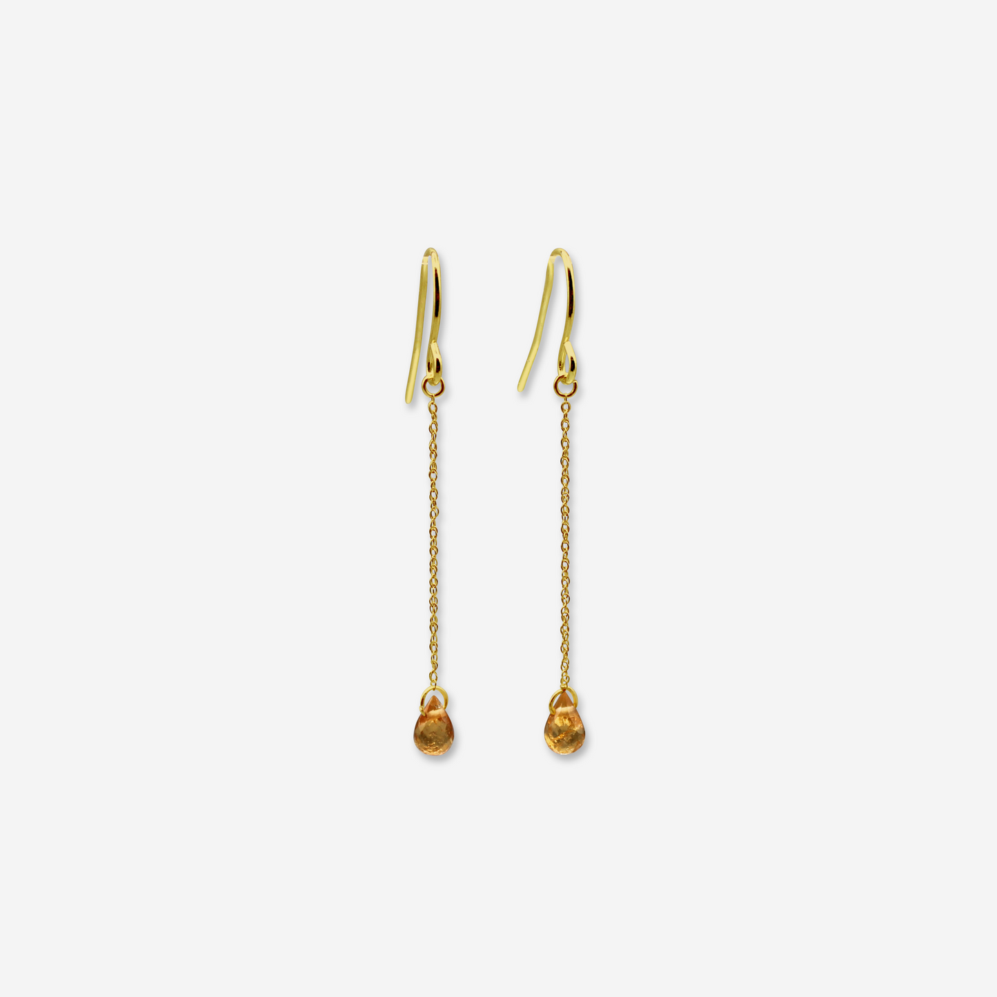 A pair of spessartite garnet drop earrings with 14 karat yellow gold hooks and chains, displaying the earrings against a white background.