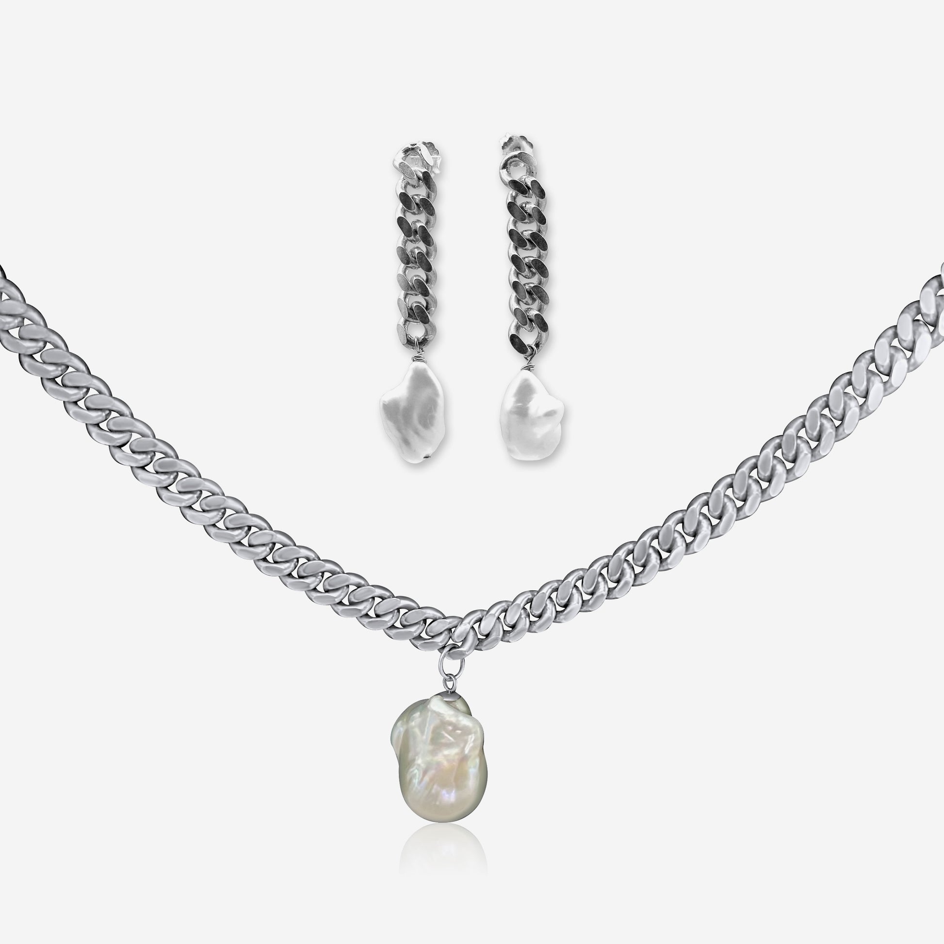 Silver necklace with pearl pendant and matching earrings on a white background