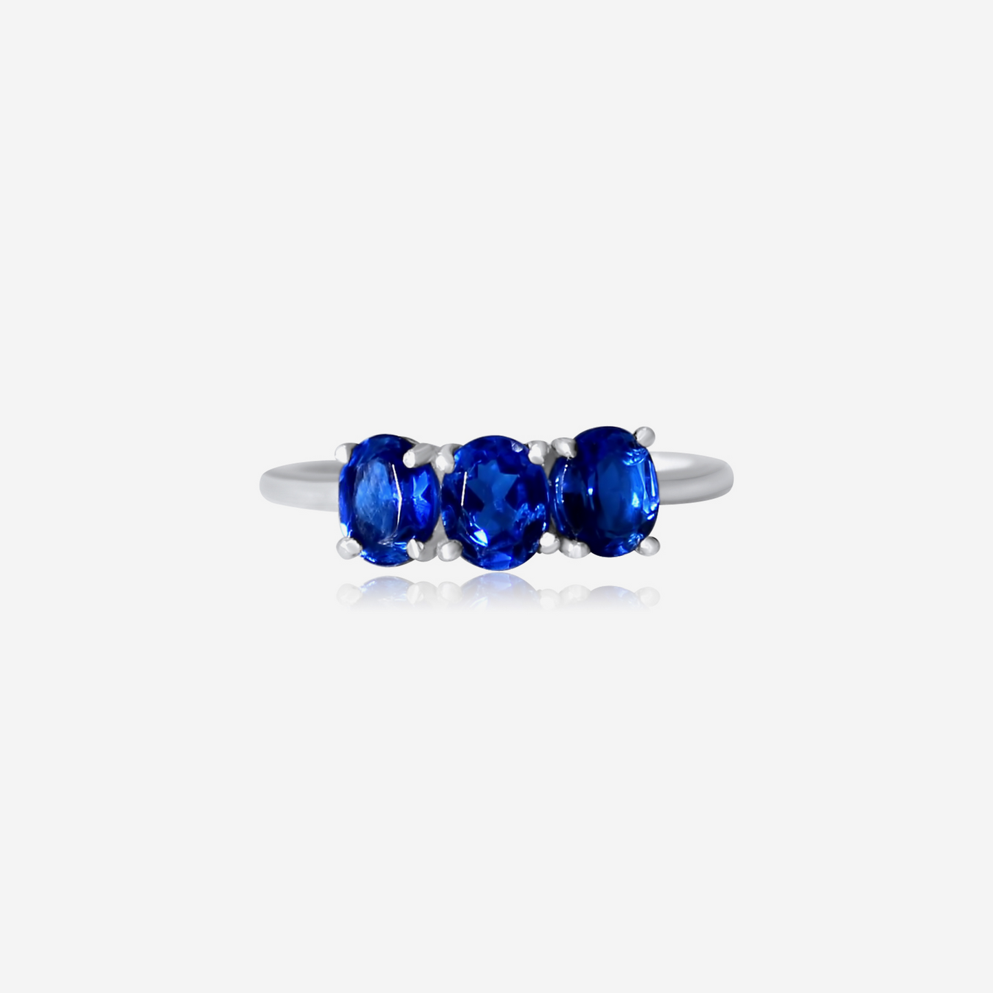 A Trio Sapphire Ring with three blue sapphire stones set in a gold band.