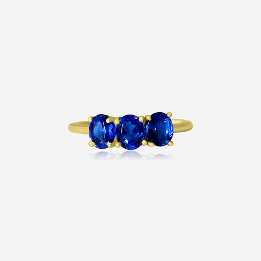 A Trio Sapphire Ring with three blue sapphire stones set in a gold band.