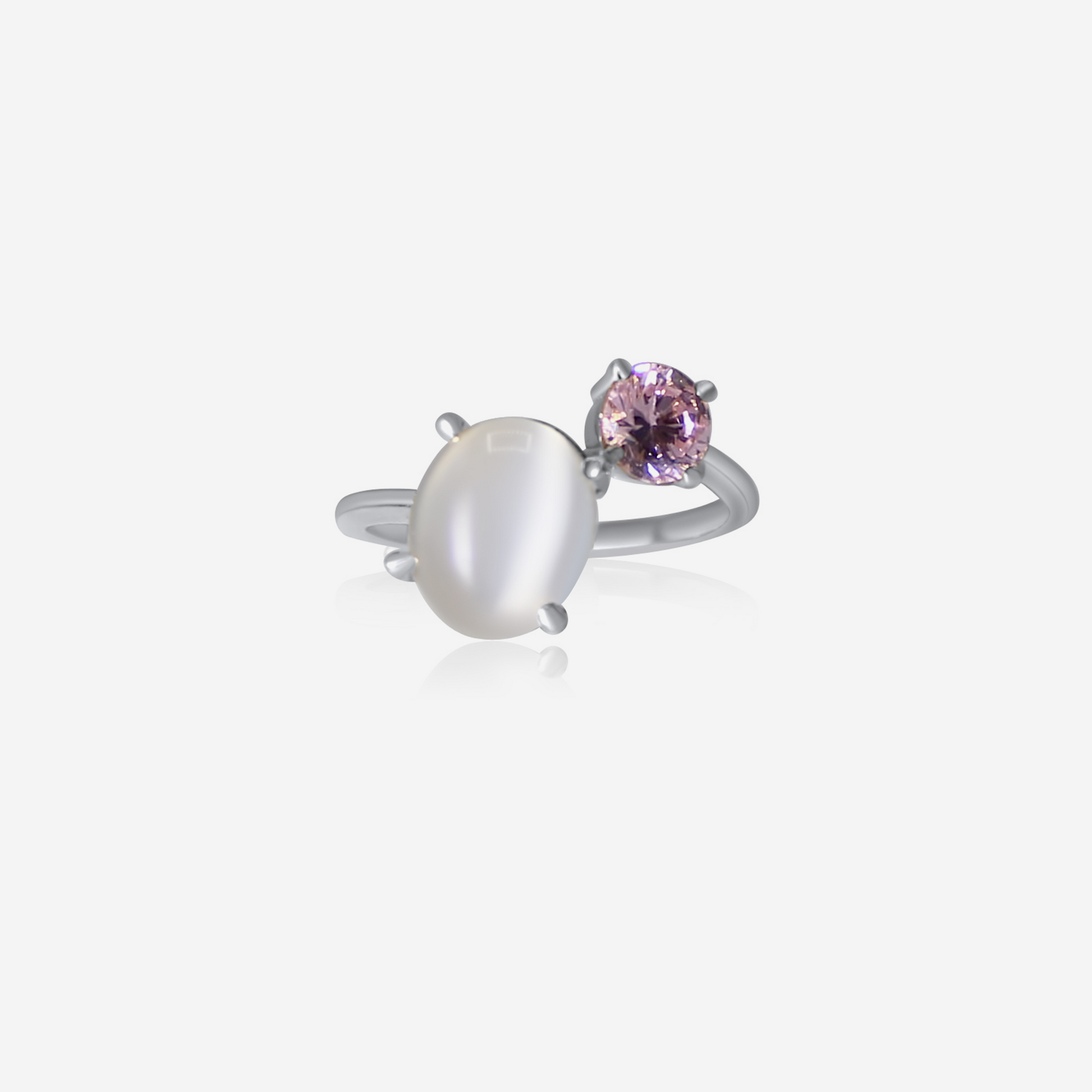 A gold-colored ring featuring an oval-shaped moonstone and a round pink tourmaline stone.