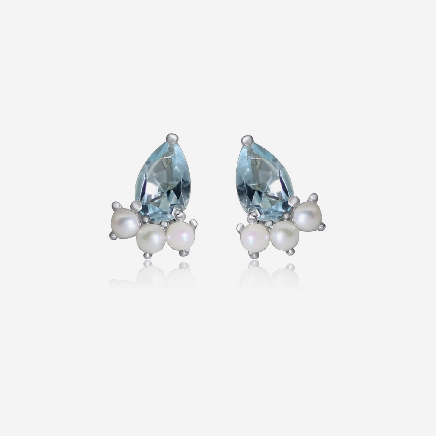 A pair of gold earrings featuring pear-shaped aquamarine stones and small round Akoya pearls arranged in a cluster.