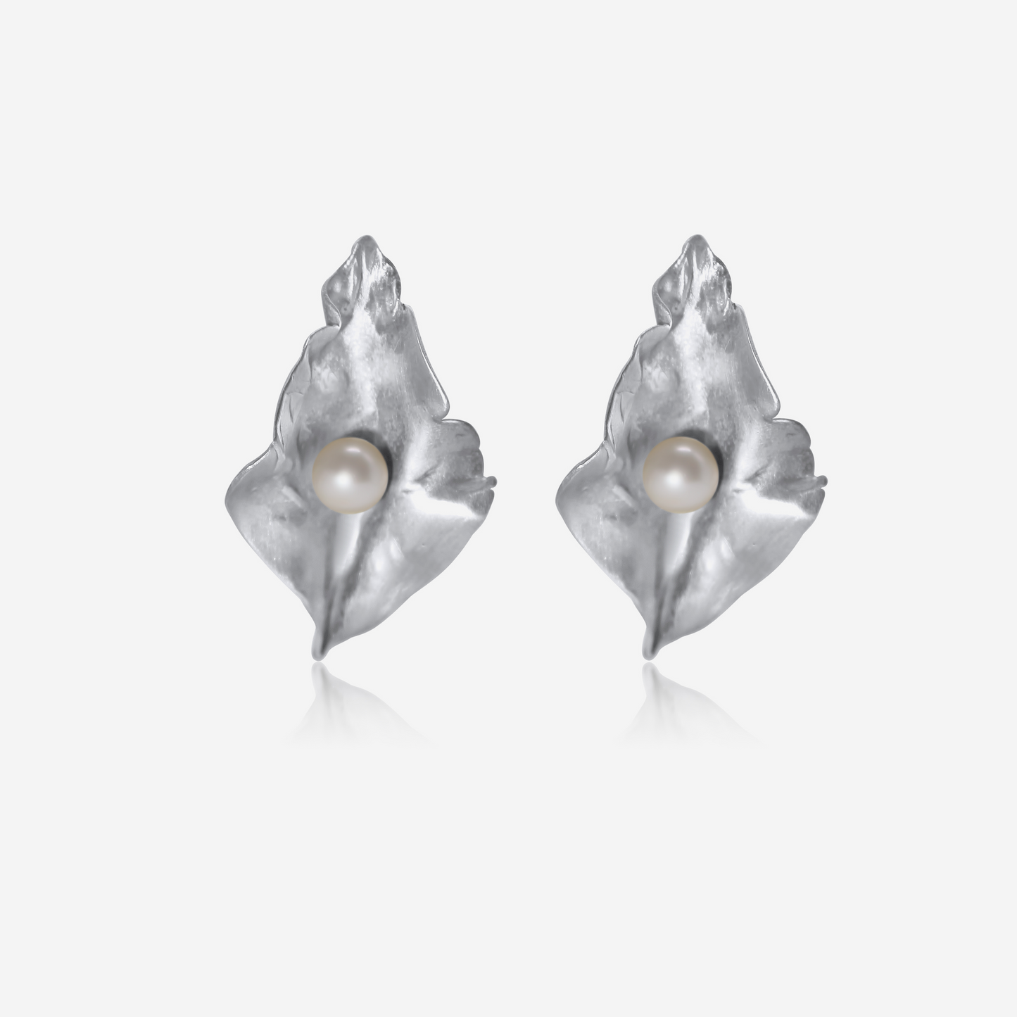 A pair of gold petal-shaped earrings with Akoya pearls at their center, displayed against a white background.