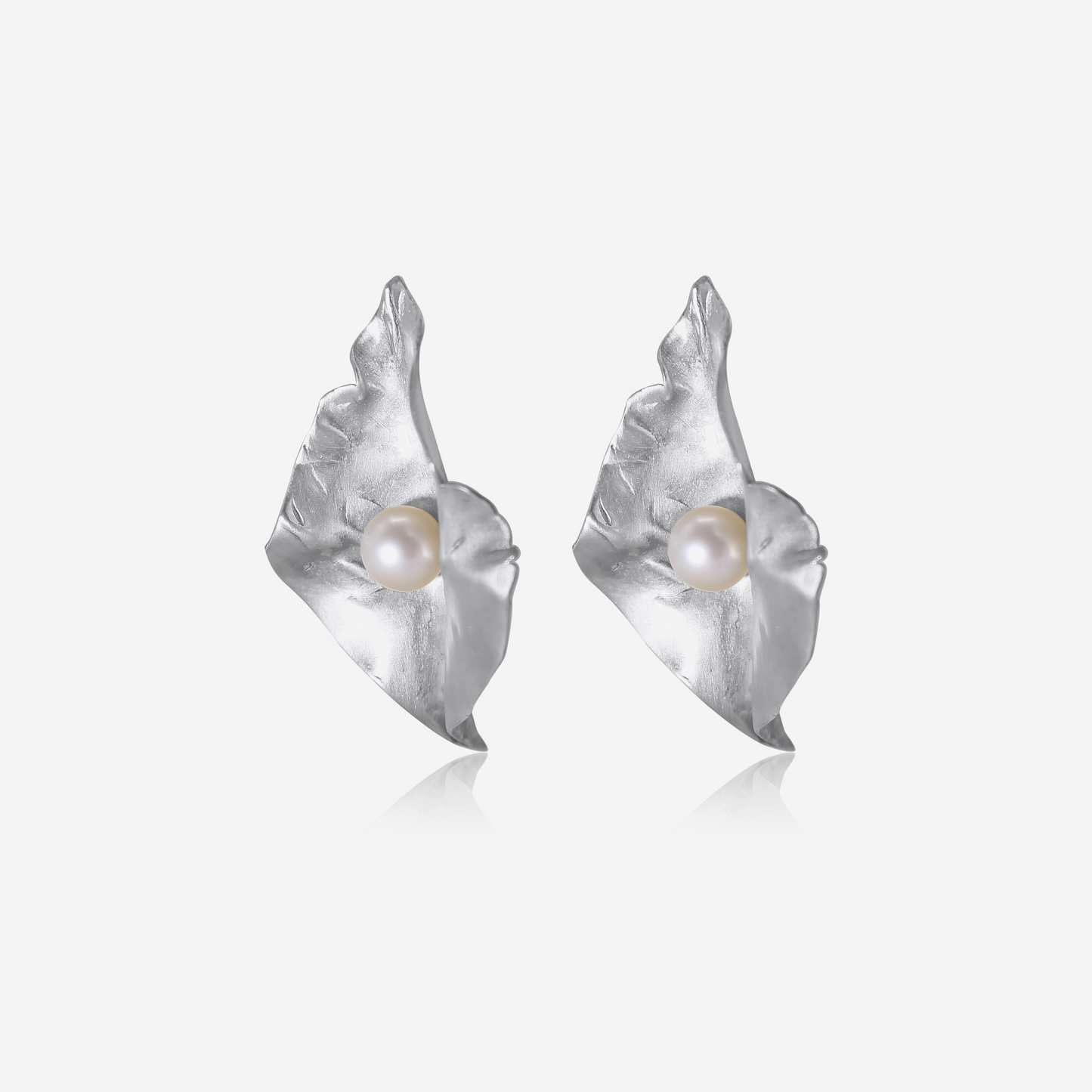 A pair of gold petal-shaped earrings with Akoya pearls at their center, displayed against a white background.