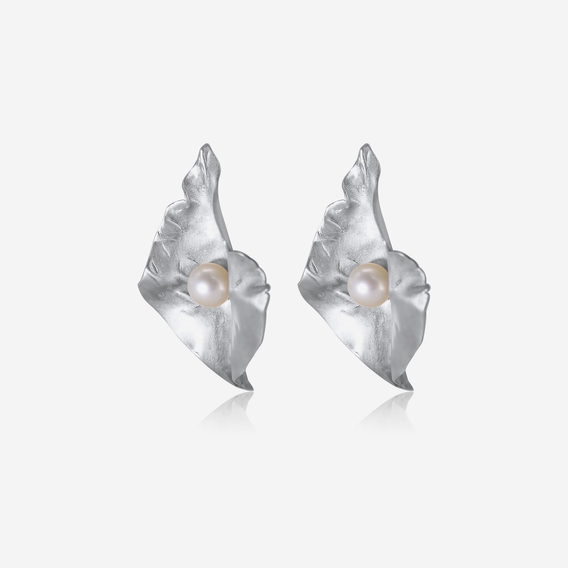 A pair of gold petal-shaped earrings with Akoya pearls at their center, displayed against a white background.