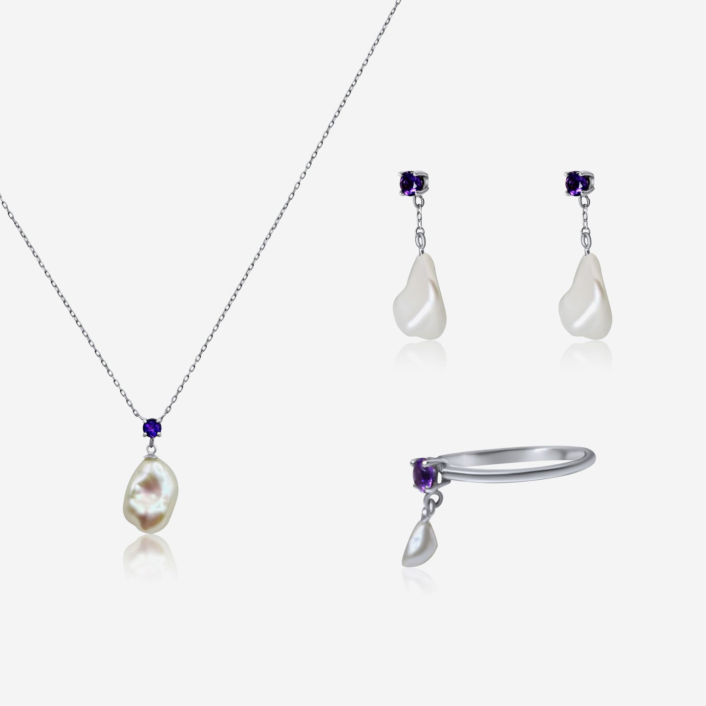 Jewelry set with necklace, earrings, and ring featuring pearls and gemstones on a white background.
