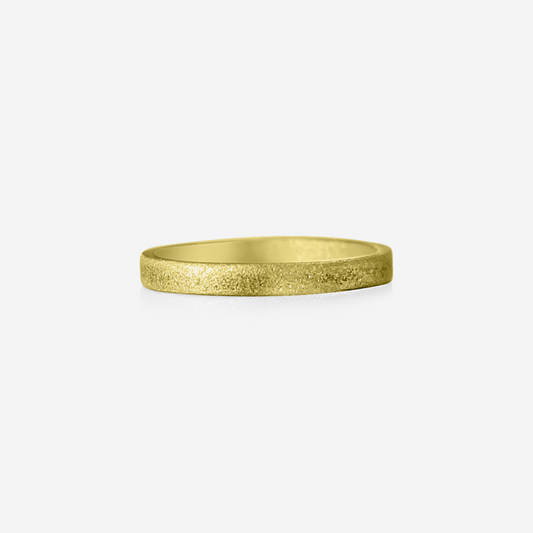 A gold-colored metal ring with a satin texture finish.