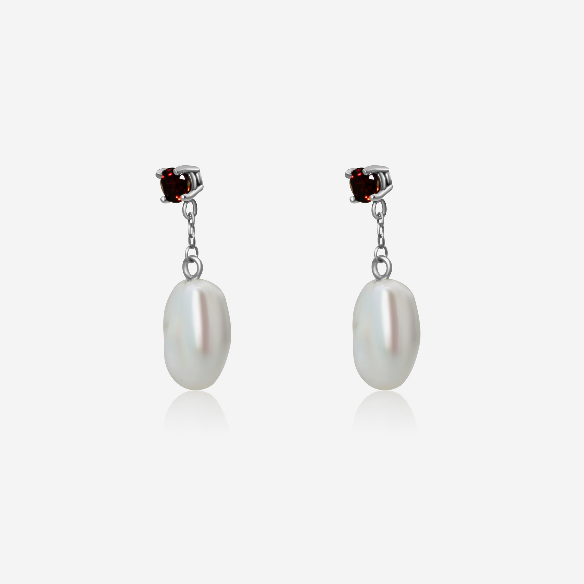 A pair of garnet with pearl drop earrings, featuring rich red garnet studs atop gold posts, with lustrous white pearls dangling below.