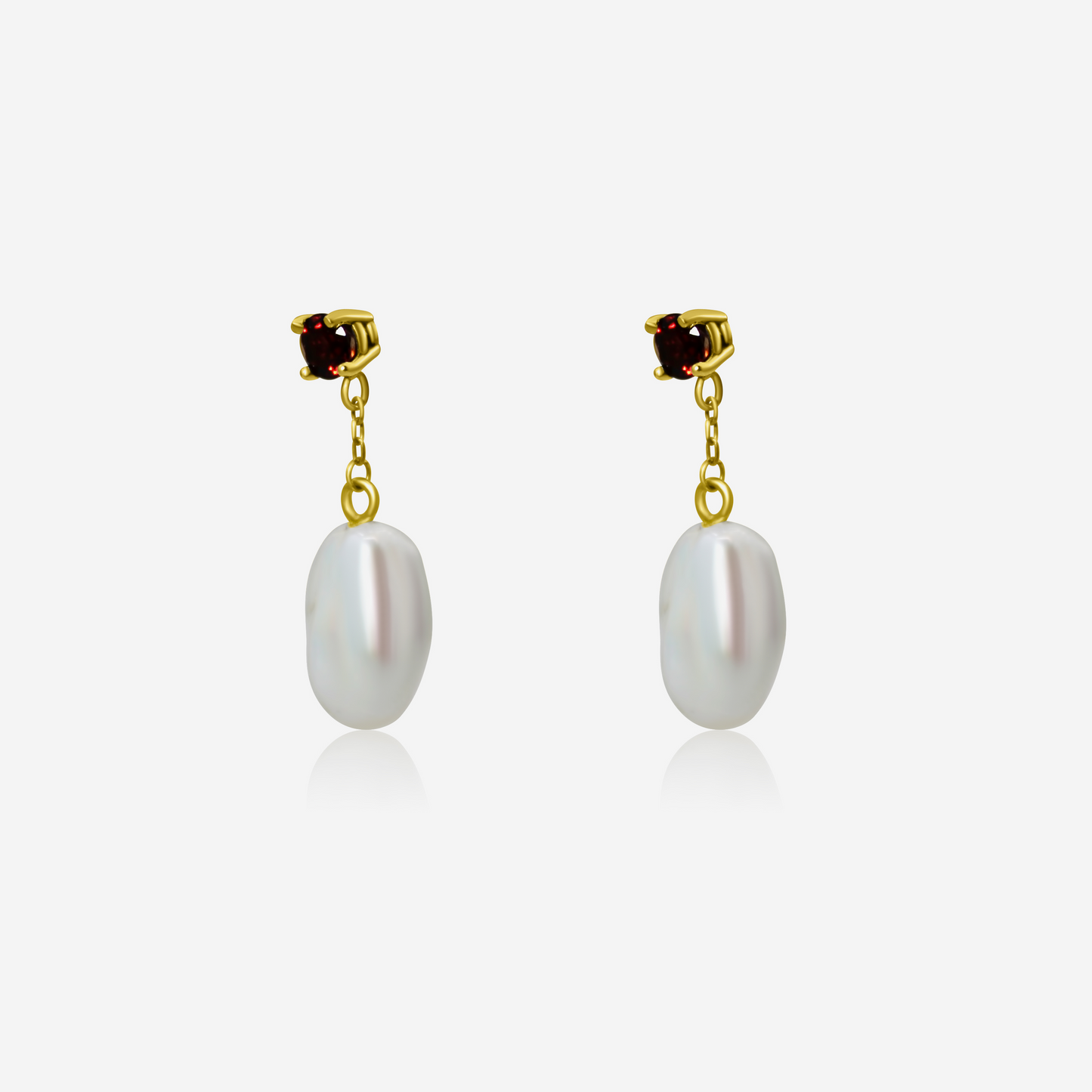 A pair of garnet with pearl drop earrings, featuring rich red garnet studs atop gold posts, with lustrous white pearls dangling below.