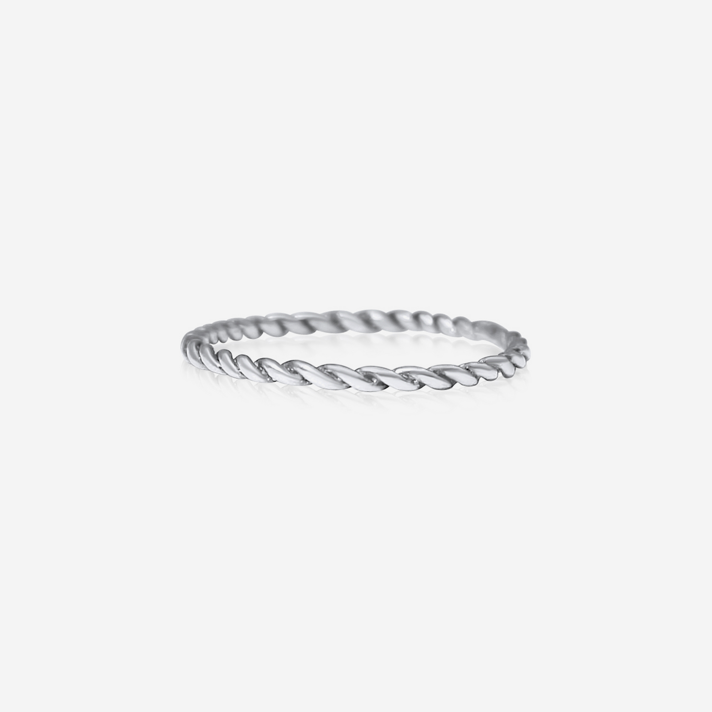 A gold-colored twisted band ring on a white background