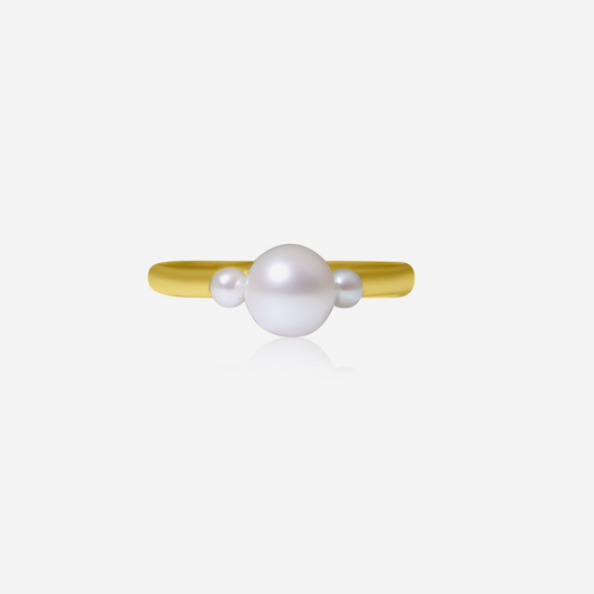 A Trinity ring featuring a central Akoya pearl with two smaller pearls on each side, set on a gold band.