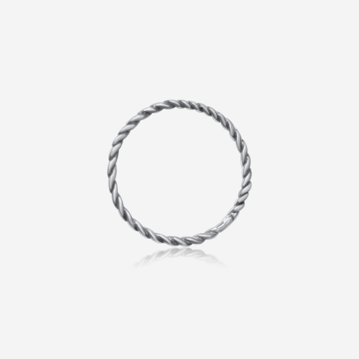 A gold-colored twisted band ring on a white background