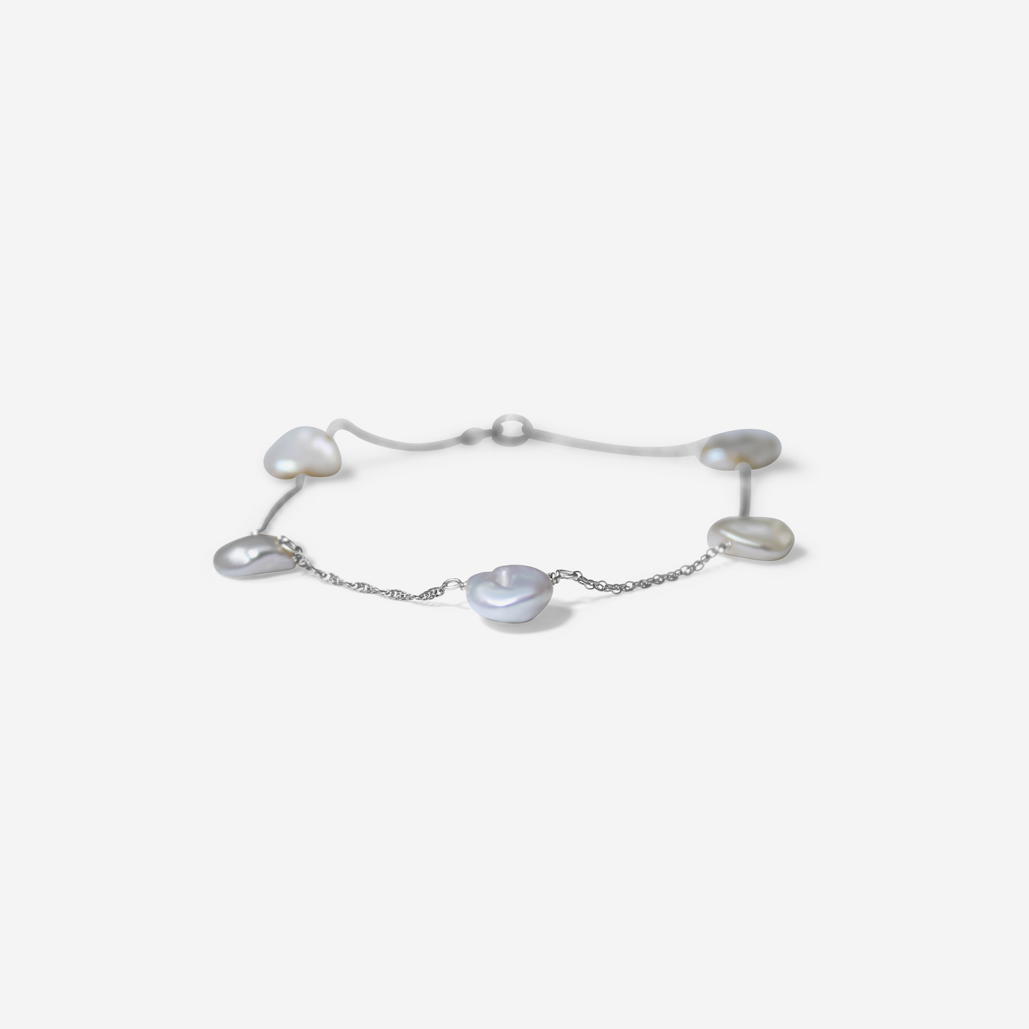 Gold bracelet with heart-shaped pearls on a light gray background