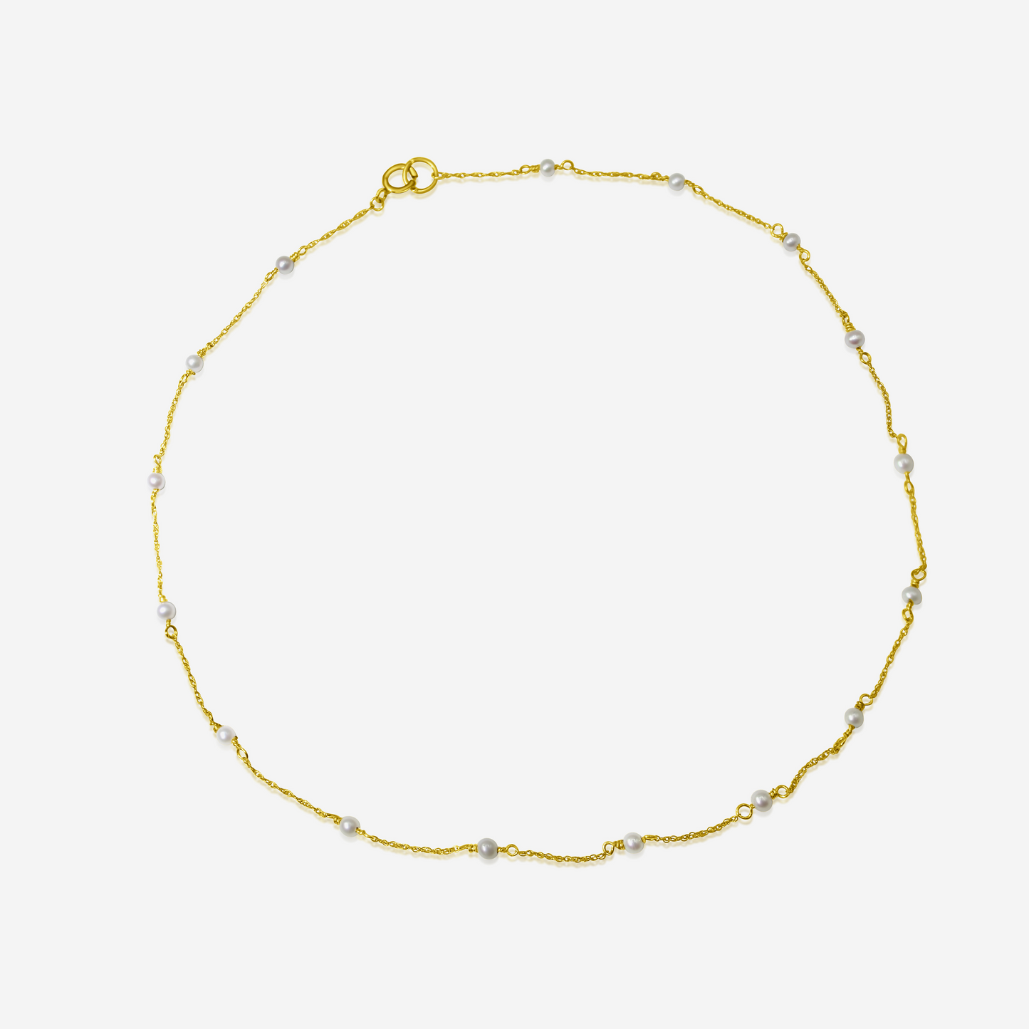 A delicate Tiny Akoya Pearl Necklace with small pearls on a gold-tone chain displayed against a white background.