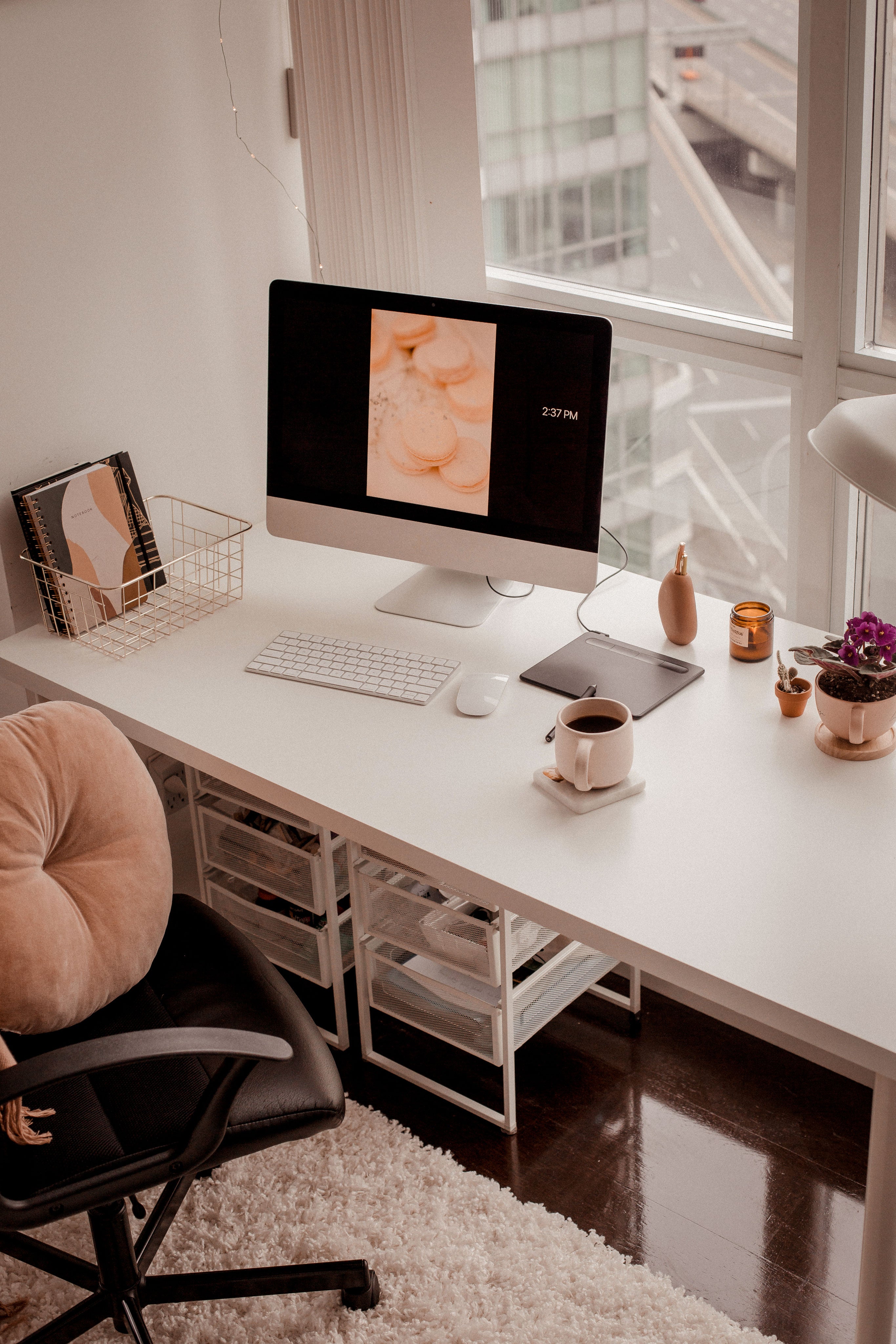 Modern home office with a desk, computer, and decor.