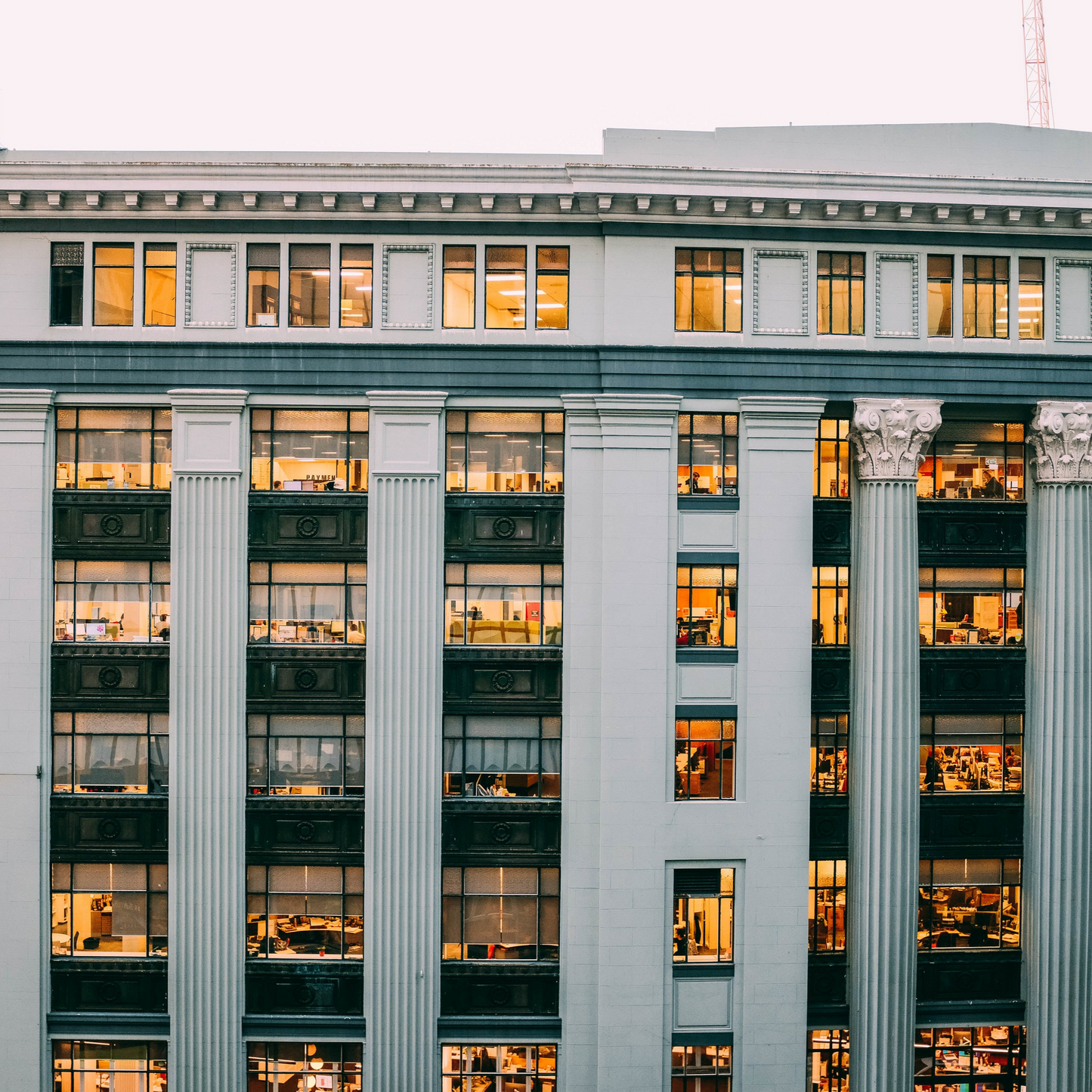 Facade of a building with columns and multiple windows, likely representing a location for a jewelry consultation service.