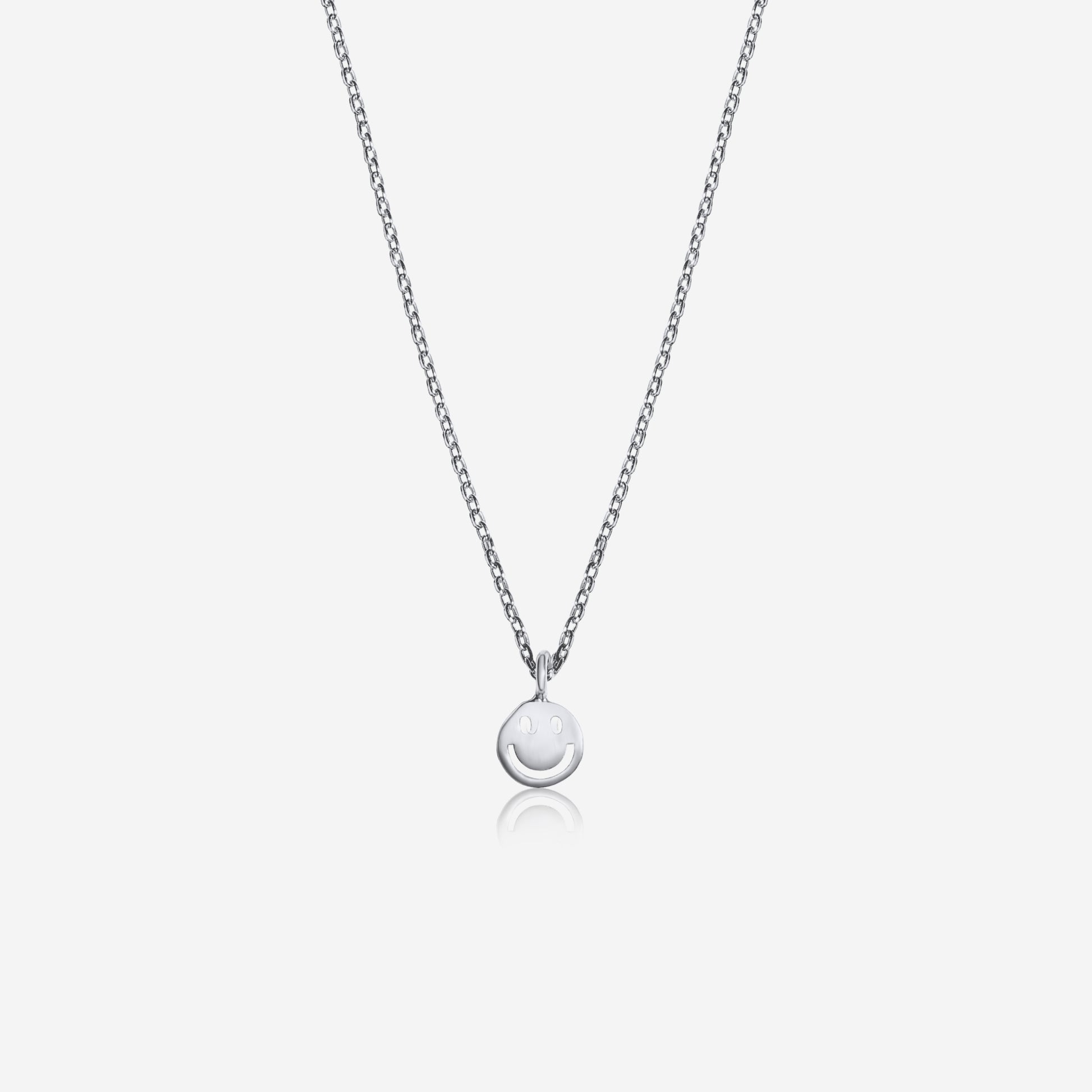 Silver necklace with a round pendant on a light gray background