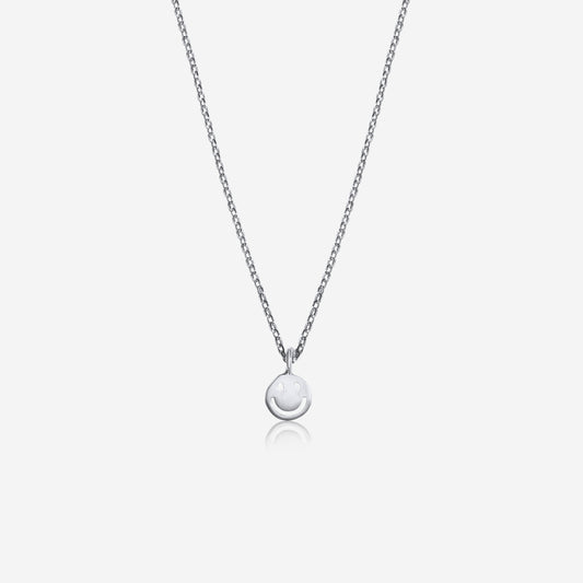Silver necklace with a round pendant on a light gray background