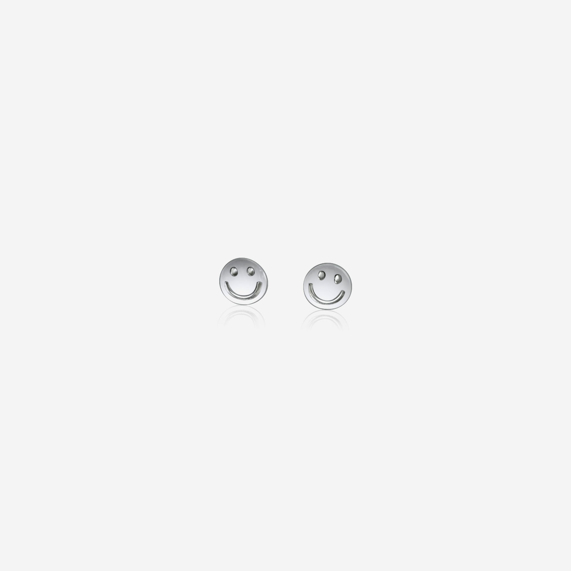 Pair of silver smiley face earrings on a white background