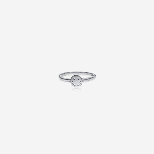 Silver ring with a smiley face design on a white background