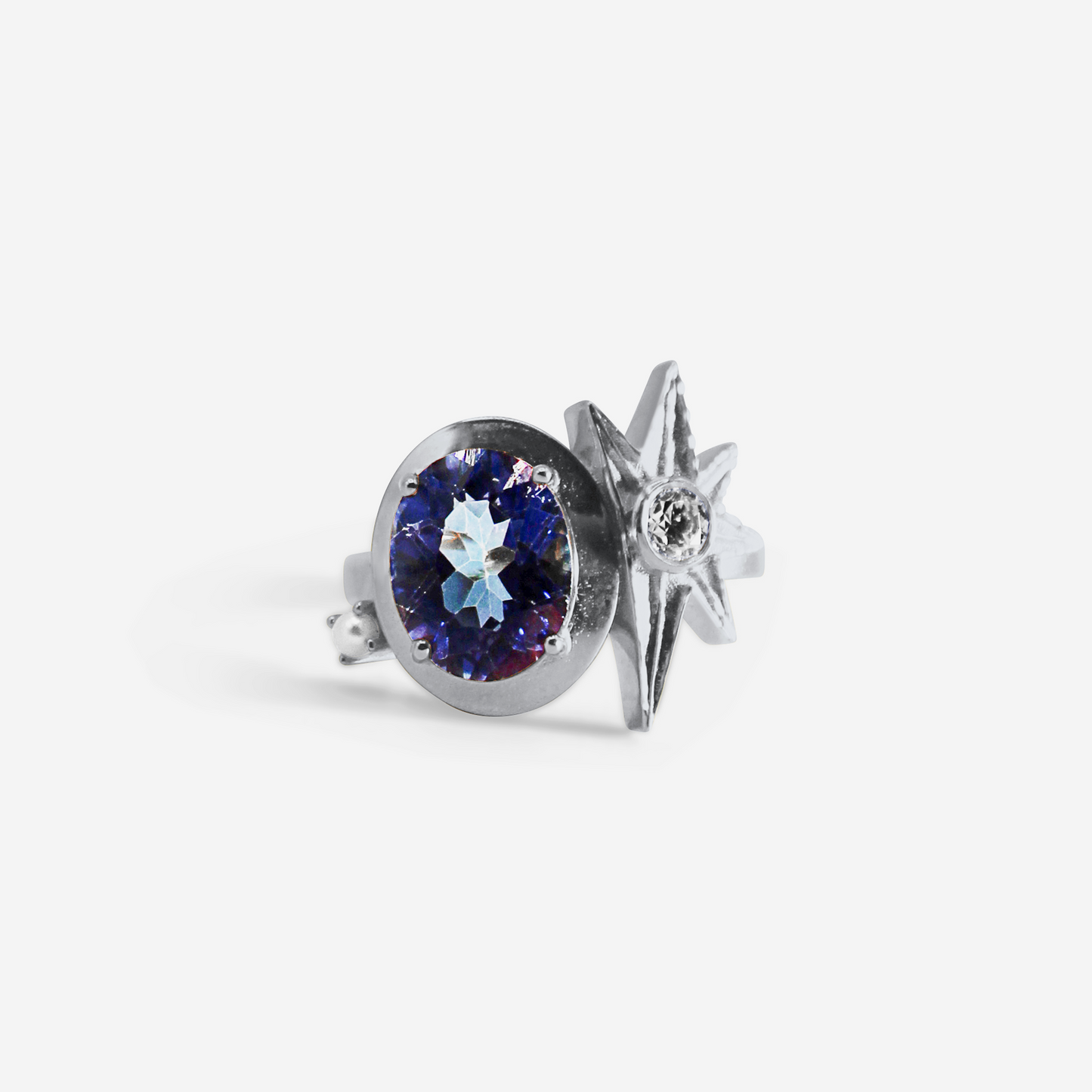 A white gold ring featuring a large purple tourmaline stone with smaller gold accents and a smaller clear diamond to the side.