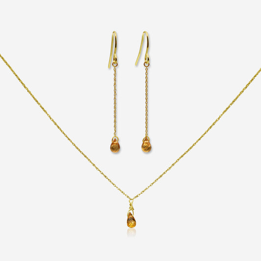 Gold necklace and earrings on a white background