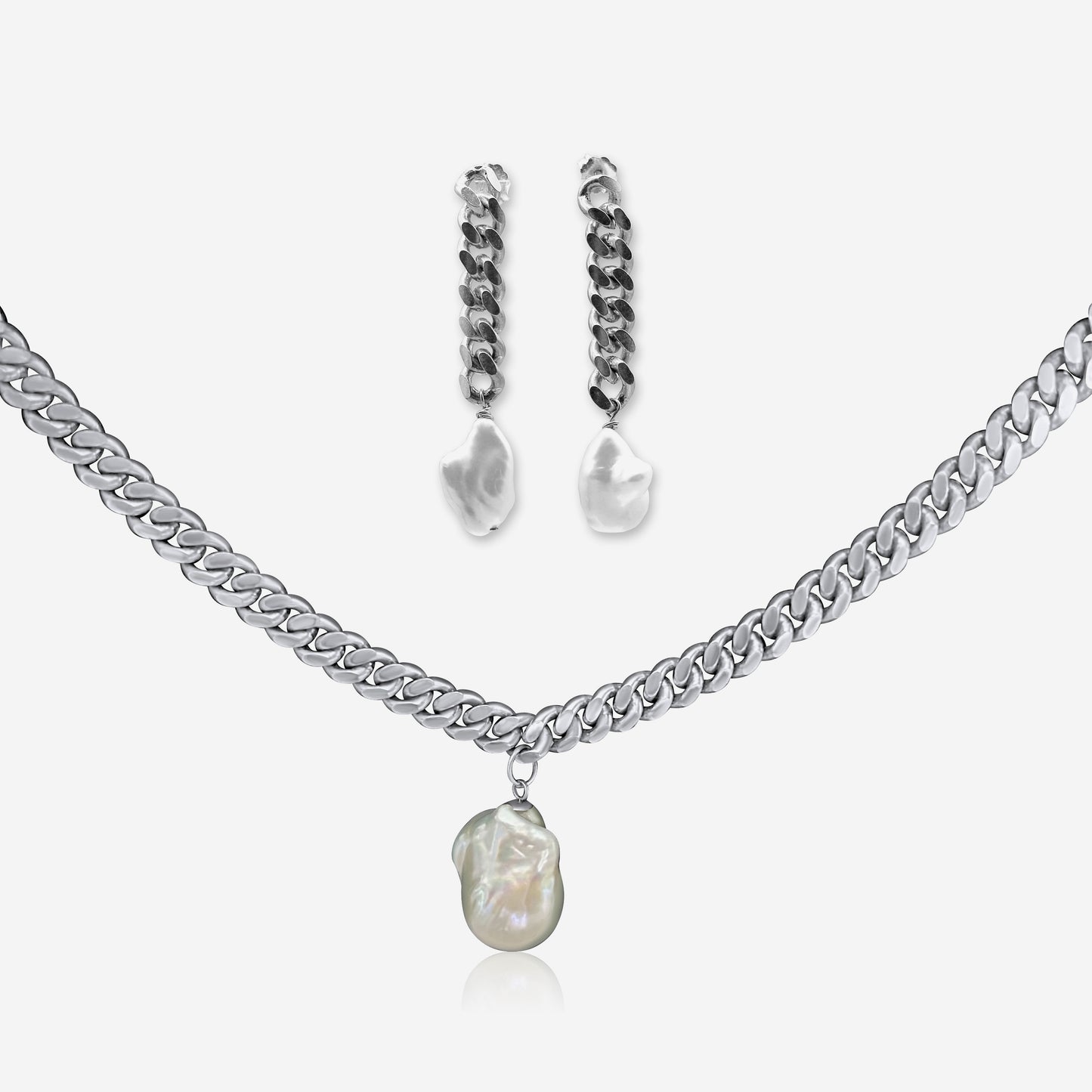 Silver necklace with pearl pendant and matching earrings on a white background