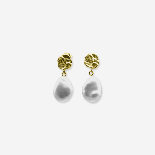 A pair of earrings featuring a sculptural design with white pearls and what appears to be a crumpled paper texture at the top