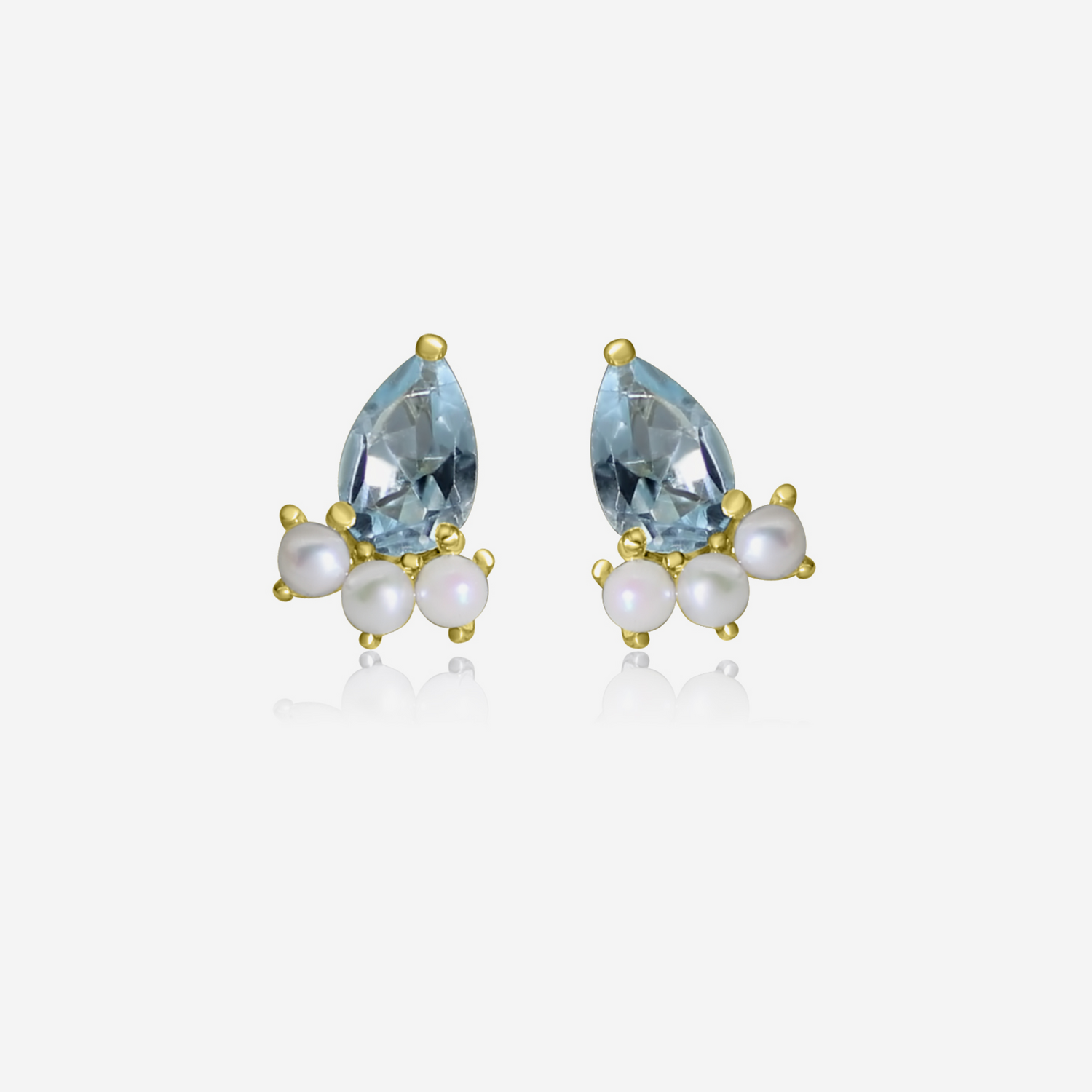 A pair of gold earrings featuring pear-shaped aquamarine stones and small round Akoya pearls arranged in a cluster.