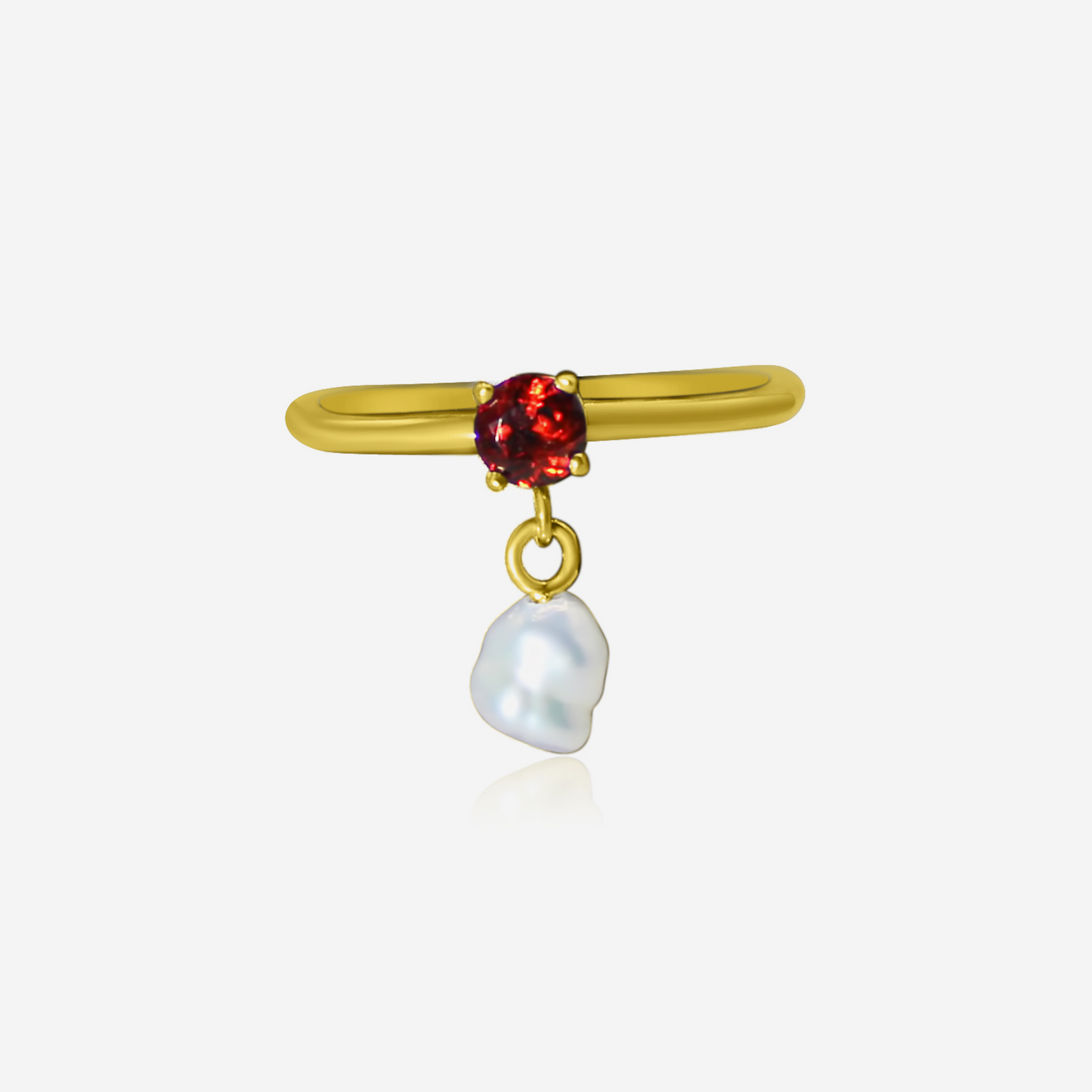A gold ring with a radiant garnet gemstone and a pearl drop