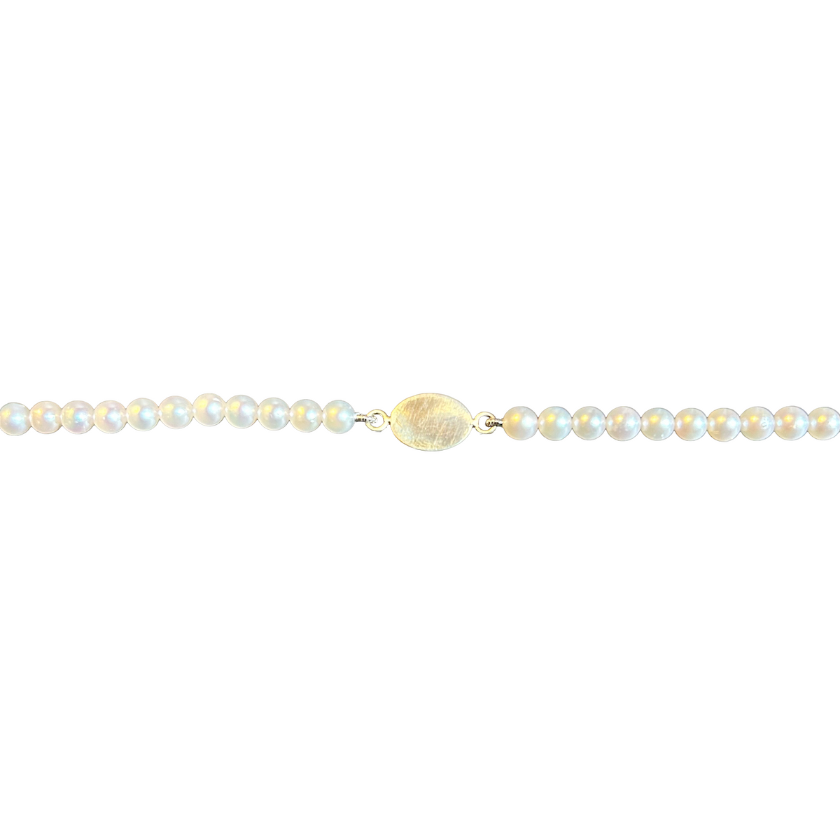 Close-up of engraved 14K gold oval plate on Akoya pearl bracelet — Made by Petit Jewelry