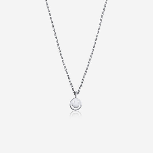 Silver necklace with a round pendant on a light gray background